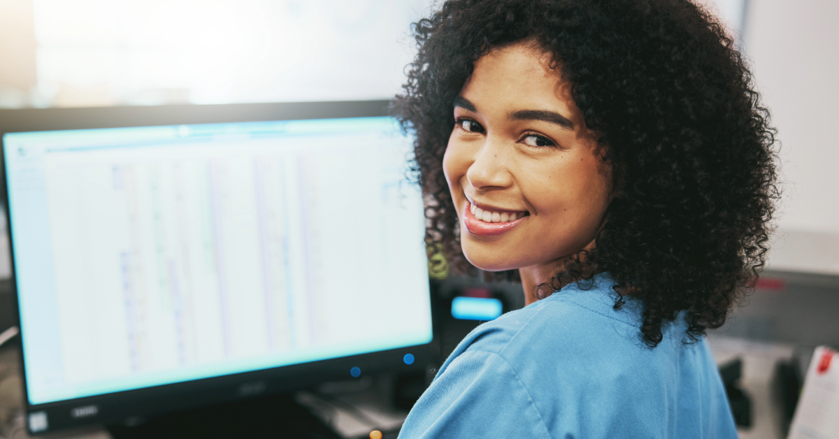 healthcare_professional_1 Happy healthcare professional smiling while working on computer